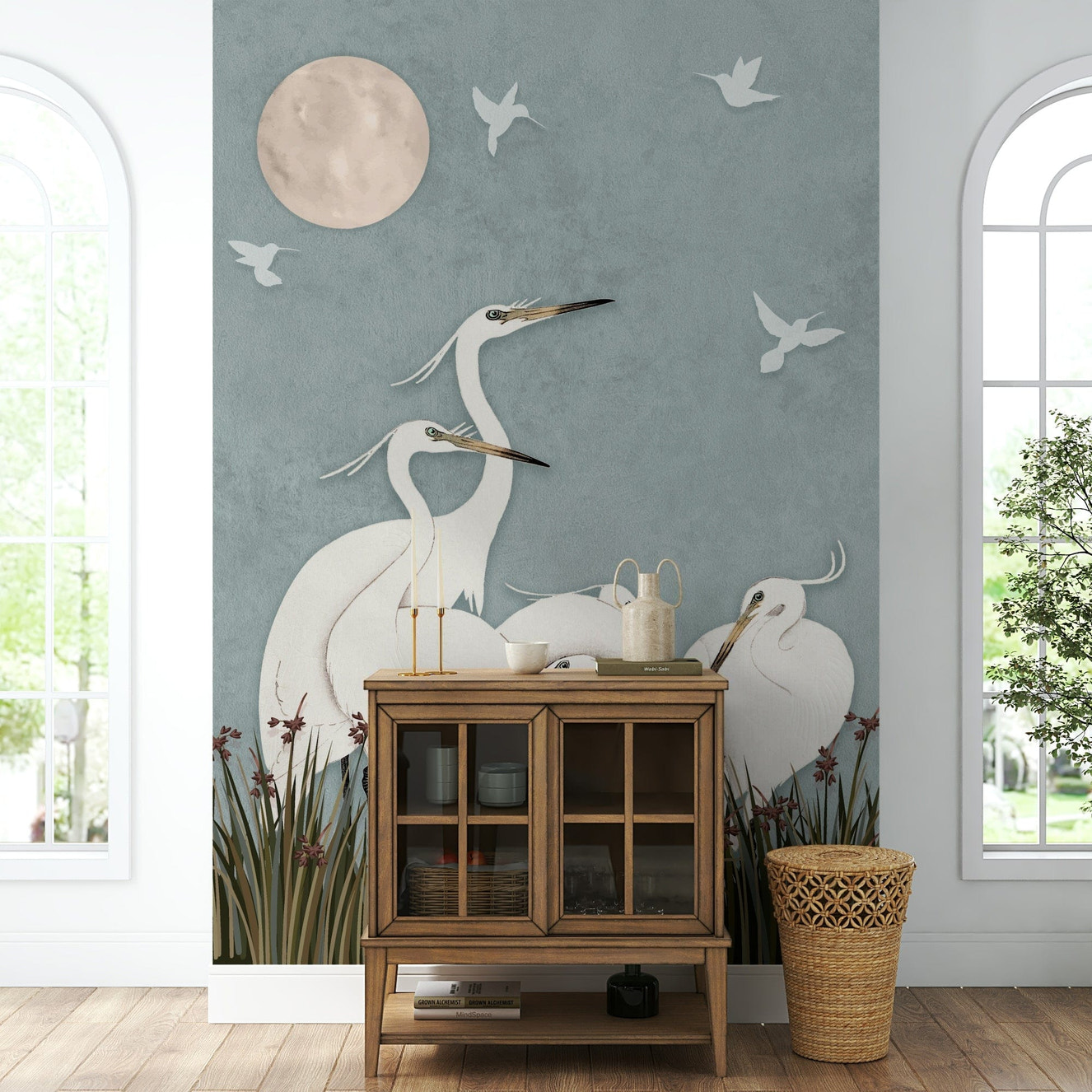 A full-wall mural of a serene night scene with egrets.
