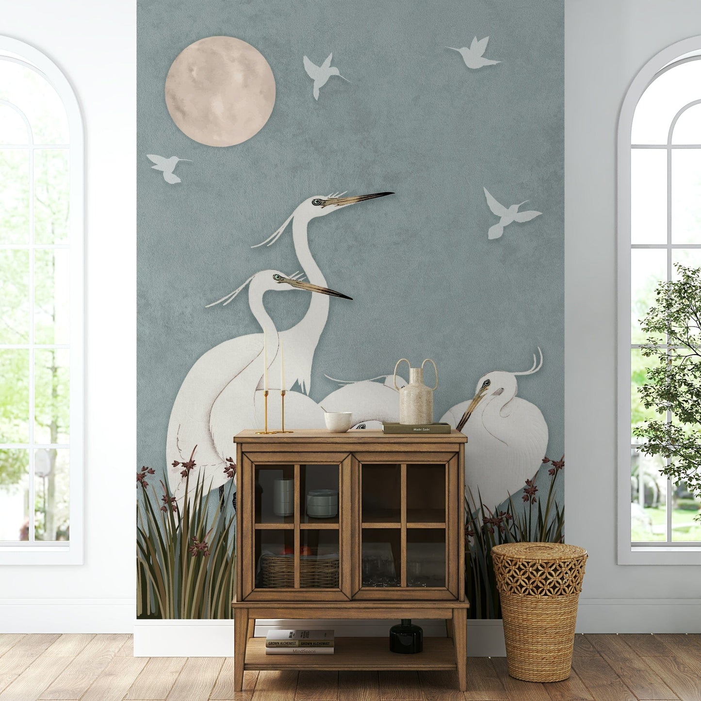 A full-wall mural of a serene night scene with egrets.
