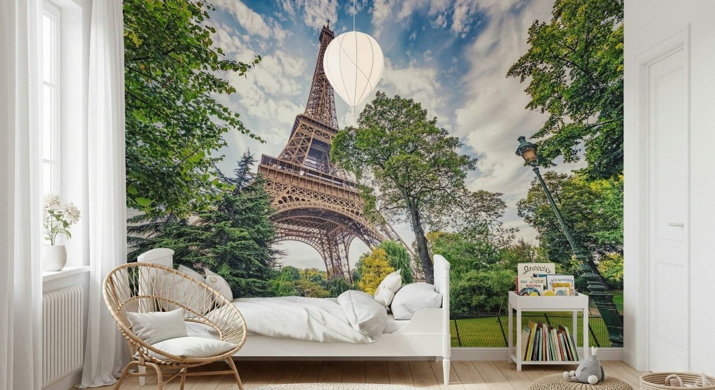 Eiffel Tower Greens wallpaper mural of the Eiffel Tower in a kids room with a white bed and rattan peacock chair