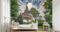 Eiffel Tower Greens wallpaper mural of the Eiffel Tower in a kids room with a white bed and rattan peacock chair