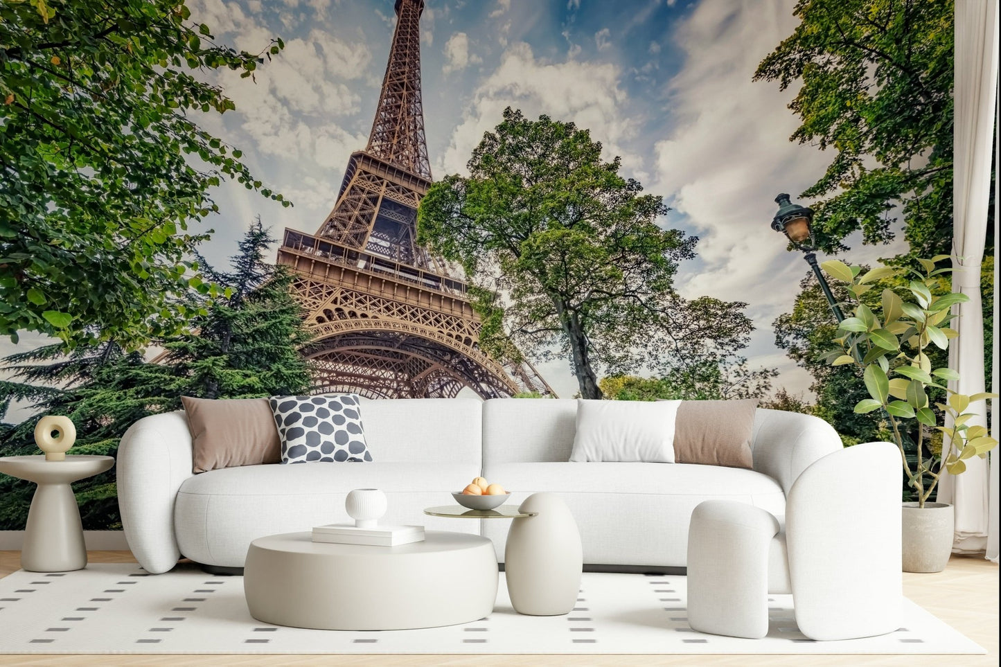 Eiffel Tower Greens wallpaper mural of the Eiffel Tower among trees behind a white curved sofa in a living room