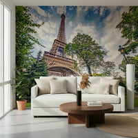 Eiffel Tower Greens wallpaper mural of the Eiffel Tower and green trees behind a white sofa and walnut table