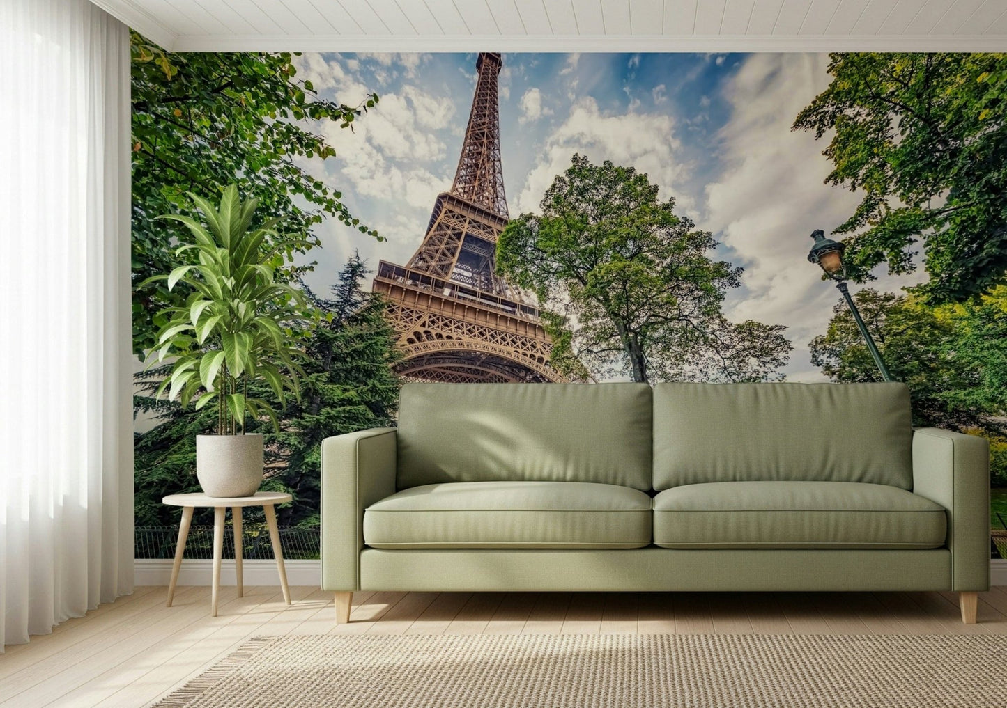 Eiffel Tower Greens wallpaper mural of the Eiffel Tower and lush trees behind an olive green sofa in a living room