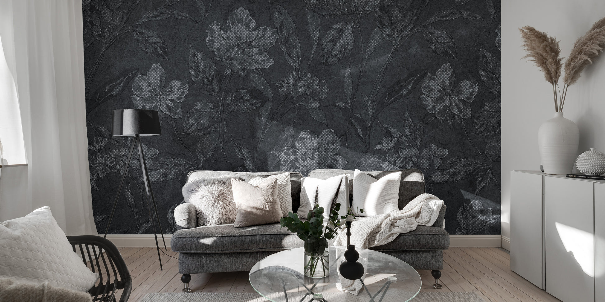 Black floral wallpaper mural installed on a living room feature wall, showing large, intricate white and pink blooms for a dramatic, luxurious effect.