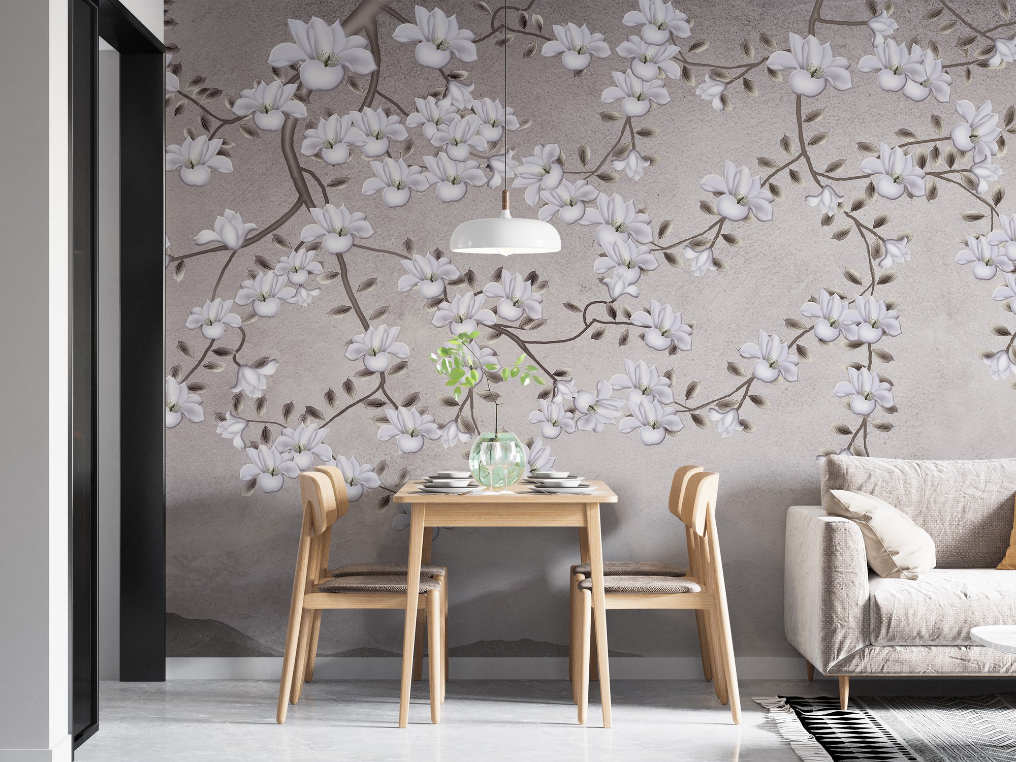 Floral Branches Mountain wallpaper mural of white magnolias on gray behind a wood dining table for two beside a sofa