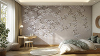 Floral Branches Mountain wallpaper mural of white magnolias behind a bed with sage throw and wood desk in a bedroom
