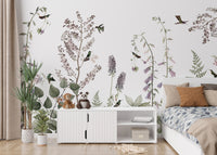 Hummingbird Hedge wallpaper mural of lilac flowers behind a white sideboard with plush toys in a kids bedroom