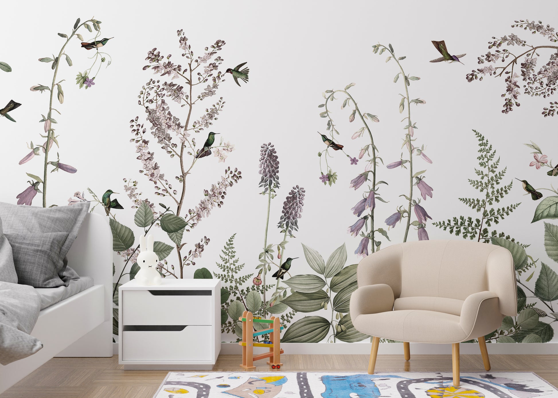 Hummingbird Hedge wallpaper mural with ferns and hummingbirds above a white toddler bed and beige armchair