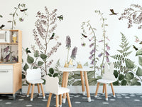 Hummingbird Hedge wallpaper mural with lilac wildflowers and hummingbirds in a kids playroom with bear-ear chairs