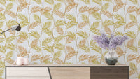 Elegant Palm Leaves wallpaper in golden-green fronds above a sideboard with a lilac vase and candles