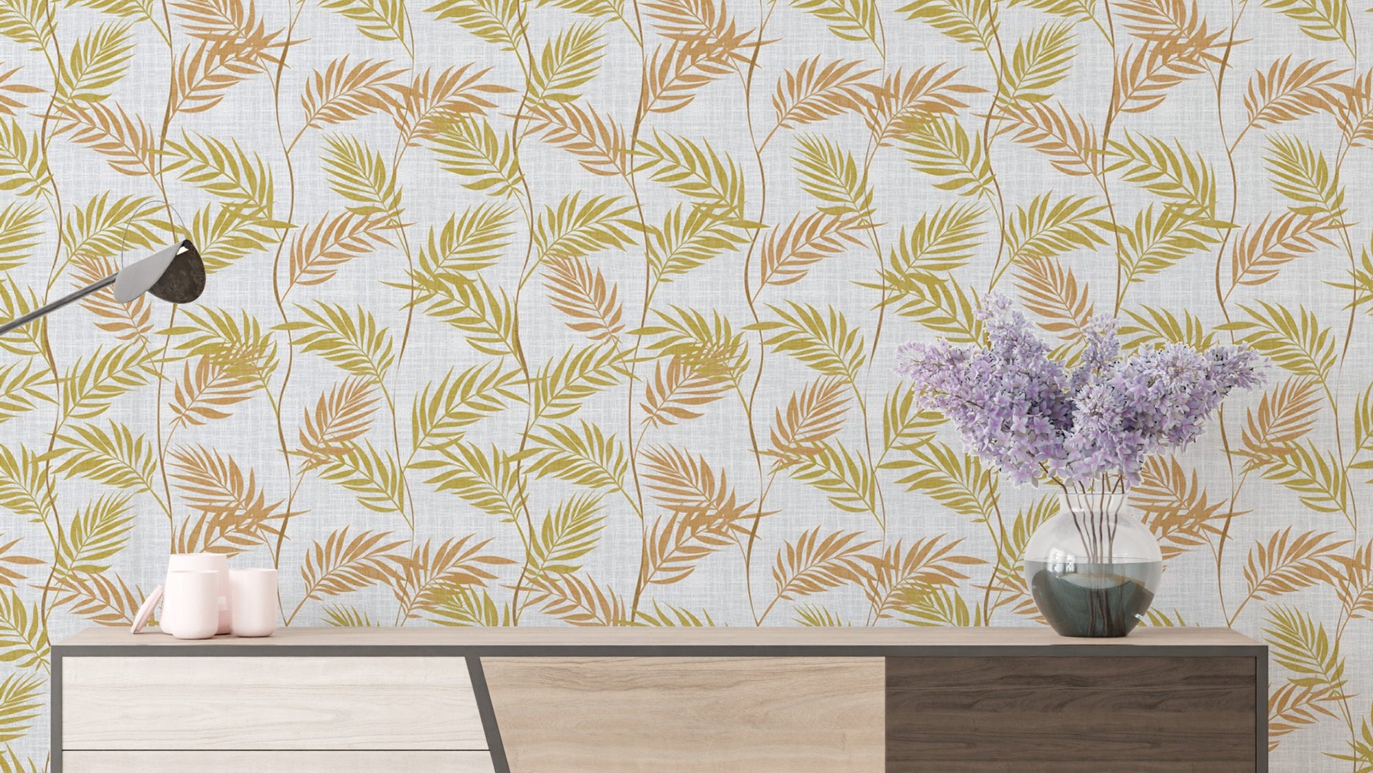 Elegant Palm Leaves wallpaper in golden-green fronds above a sideboard with a lilac vase and candles
