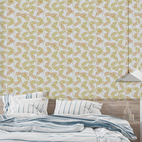 Elegant Palm Leaves wallpaper behind a bed dressed in blue striped bedding under a pendant light
