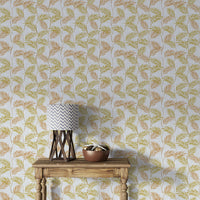 Elegant Palm Leaves wallpaper behind a wood console table with a grey chevron lamp and copper bowl