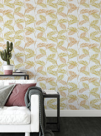 Elegant Palm Leaves wallpaper behind a white sofa with a pink cushion and a potted cactus on a side table