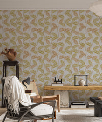 Elegant Palm Leaves wallpaper in a living room behind a woven cane armchair, wood bench and terracotta urn