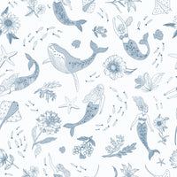 Enchanted Ocean wallpaper shown as a full-wall mural of blue line-art whales and mermaids on white