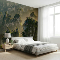 Grandiose peaks wall covering, hazy cliffs, rich green foliage, nature wallpaper.