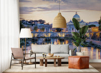 Eternal City Lights wallpaper mural of the Rome skyline above a grey sofa with a rattan pendant and leather pouf