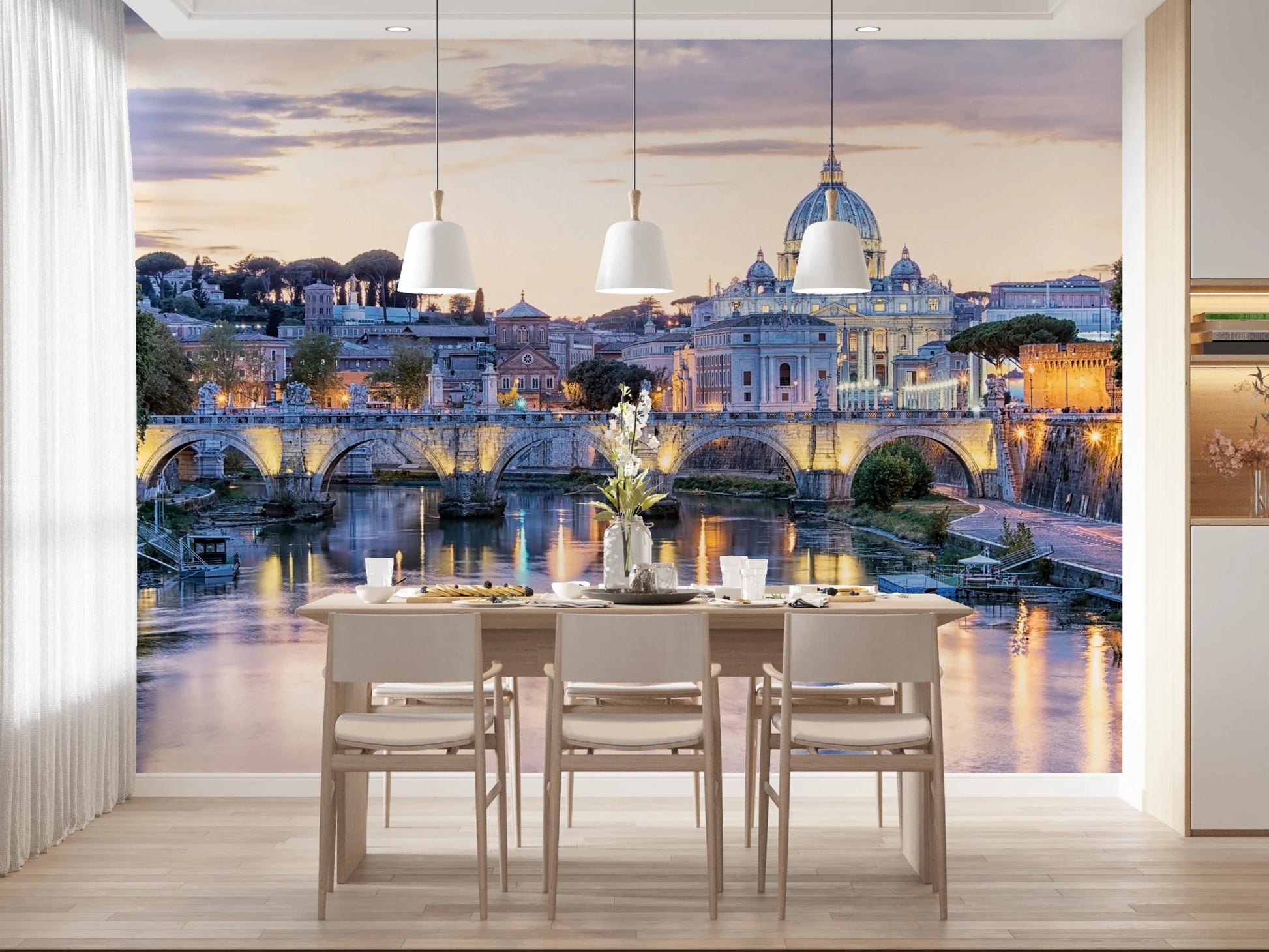 Eternal City Lights wallpaper mural of St Peter's and the lit Tiber bridge behind a pale wood dining table and chairs