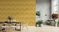 Ethnic Echoes wallpaper in mustard yellow behind a black dining table and chairs with potted plants