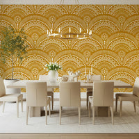 Ethnic Echoes wallpaper in mustard yellow behind a white dining table and chairs under a chandelier