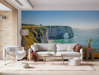 Etretat cliff arches wall mural with yellow blooms, green color shades and sea wallpaper waterline