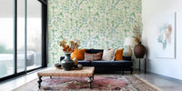 Large scale botanical wallpaper in a bright kitchen area with modern cabinetry.