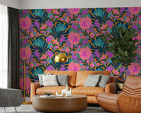 Exotic Bloom wallpaper with purple parrots and pink flowers behind a caramel leather sofa and gold arc lamp