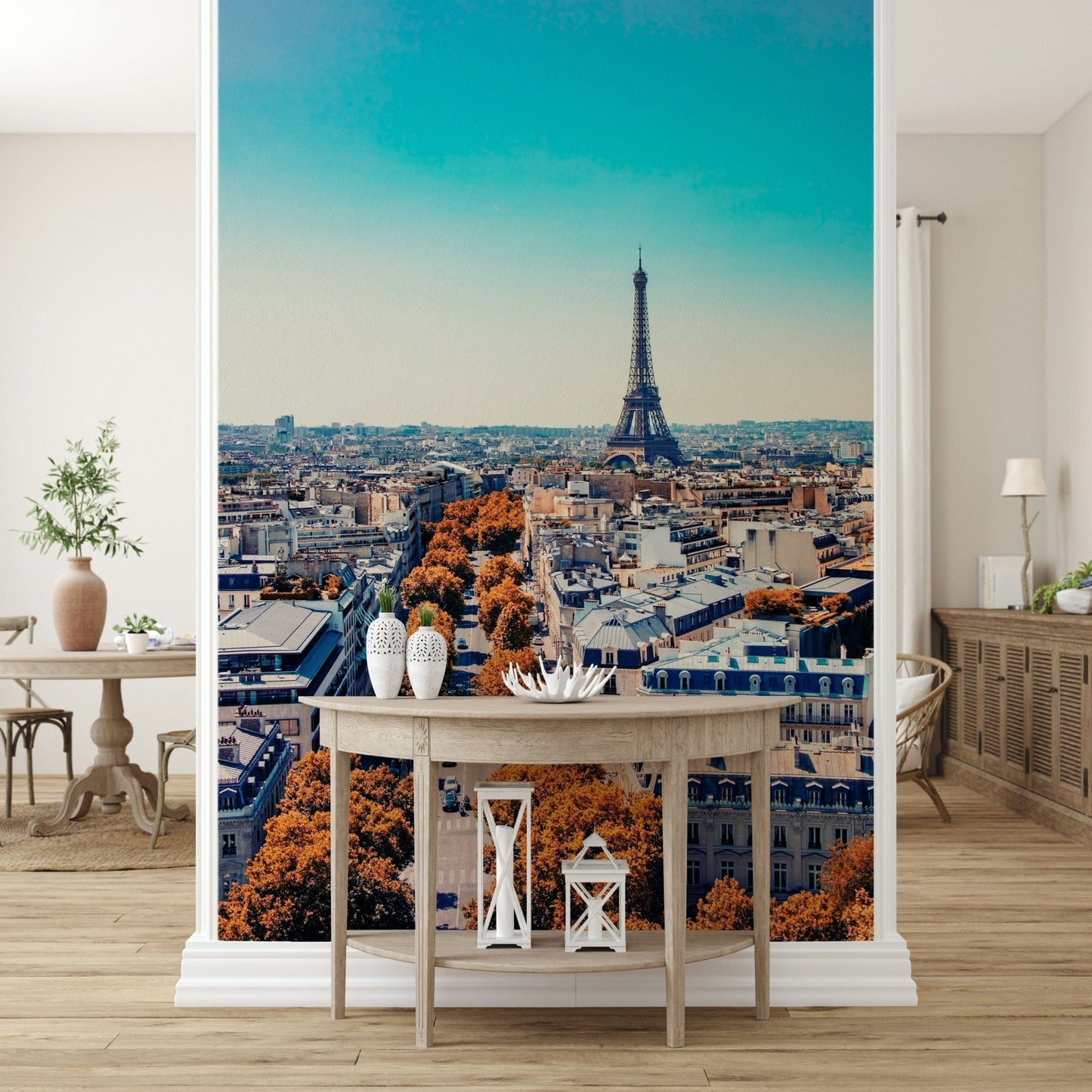 Fall in Paris wallpaper mural of the Paris skyline behind a demilune console table with lanterns in an entryway
