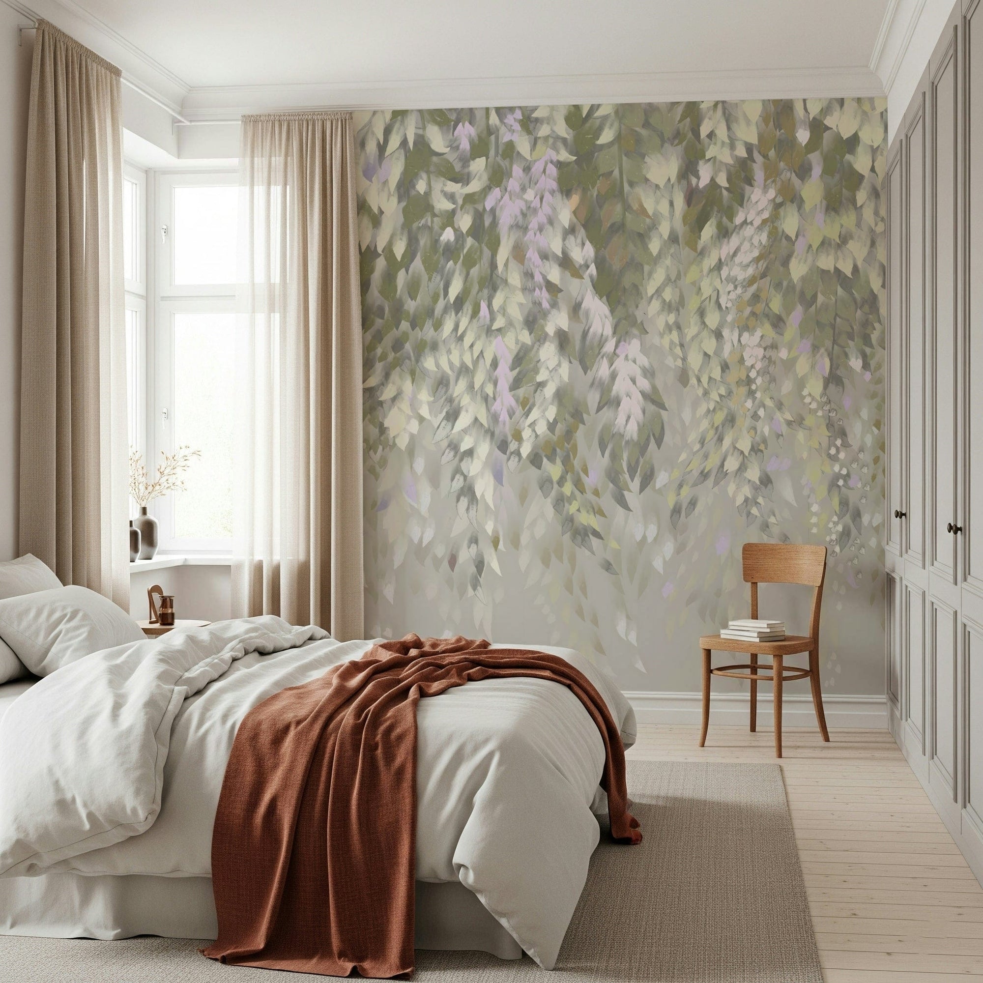 Falling Leaves Serenity wallpaper mural with soft green leaves behind a white bed and rust throw in a serene bedroom