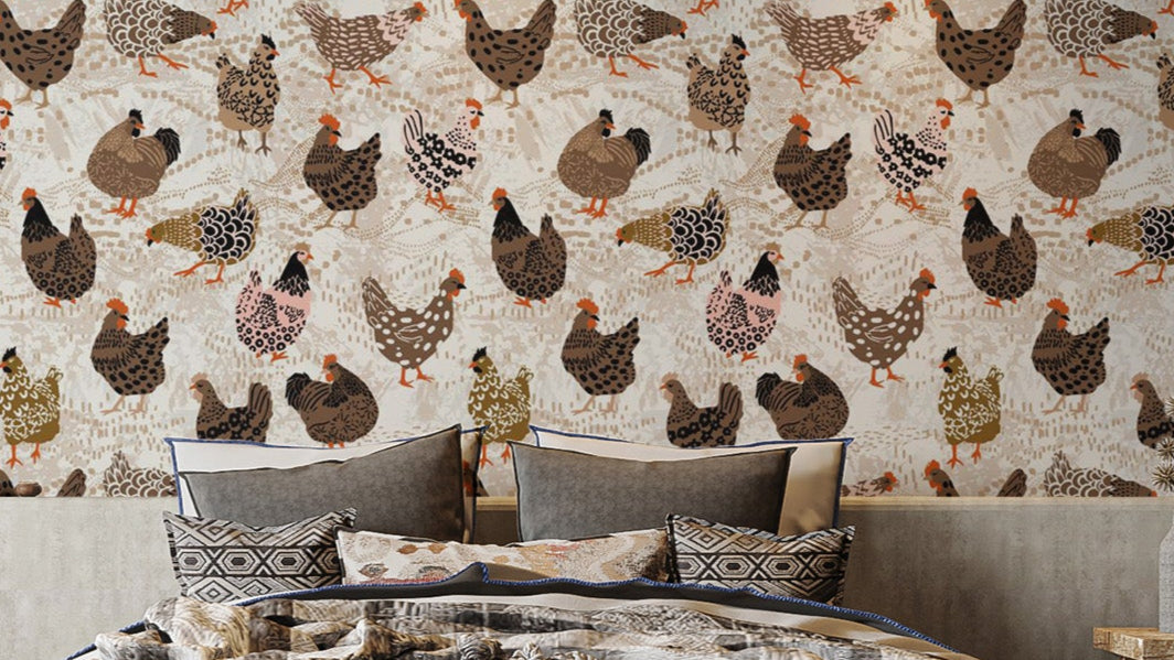 Flock of Fancy Fowl wallpaper with brown and pink illustrated hens above a grey-pillowed bed in a bedroom