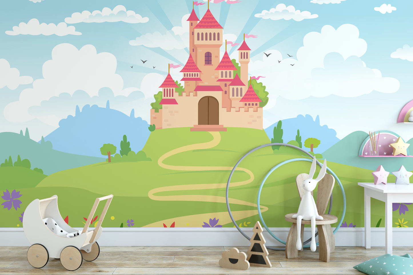 Fantacy Castle wallpaper with a pink fairytale castle on a green hill in a girls room with a toy pram and bunny on a wooden chair