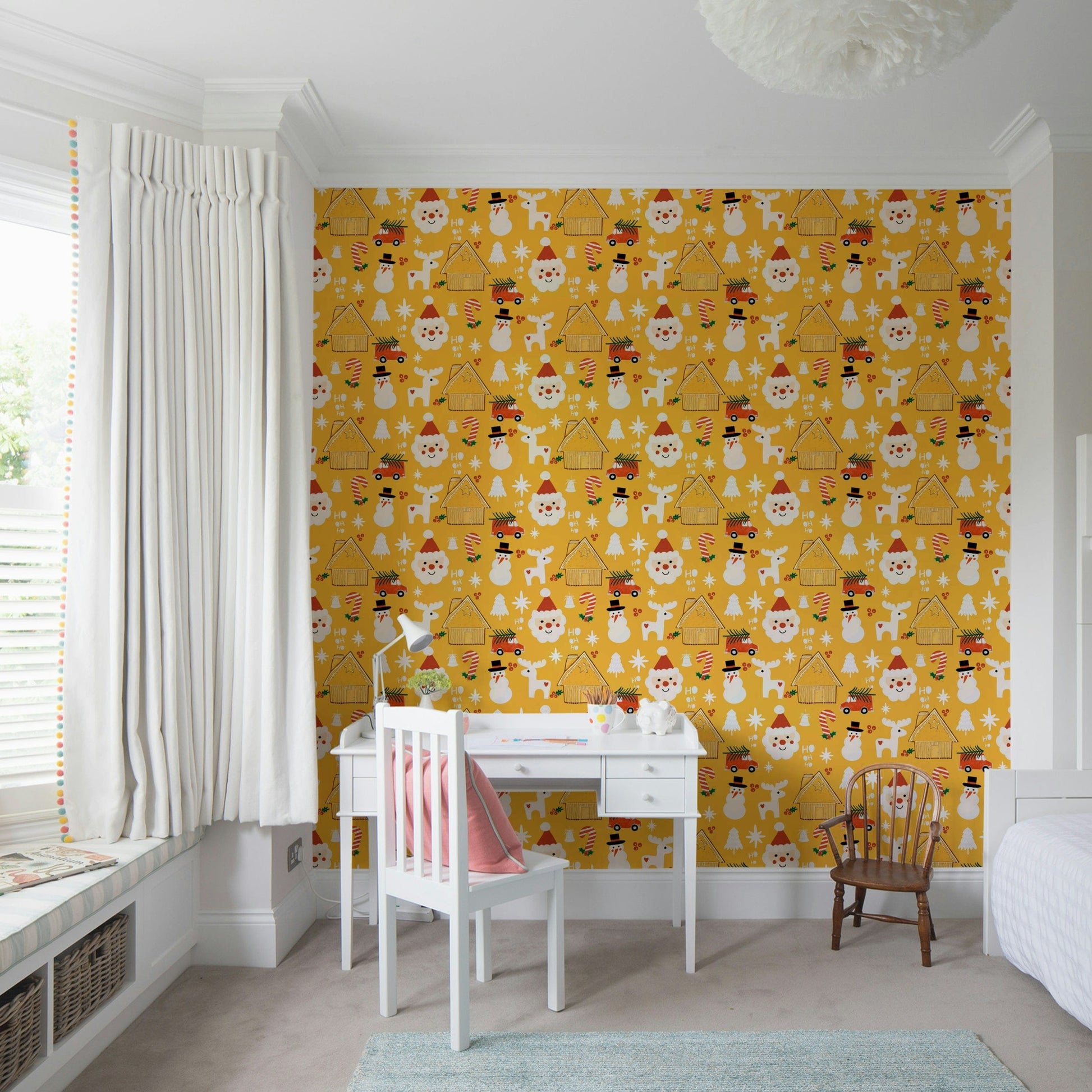Cute Christmas motifs—including reindeer, cottages, and snowmen—create a joyful pattern on this yellow holiday wallpaper.