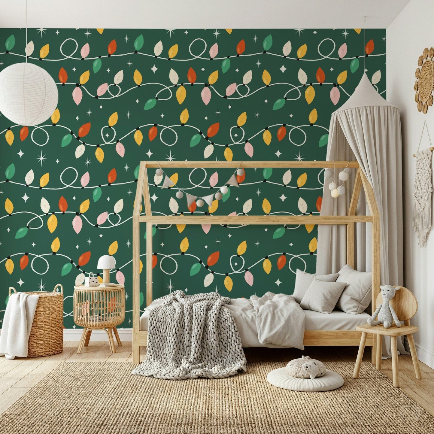 Vintage-style Christmas lights looping across a dark green wallpaper in cheerful holiday colors.