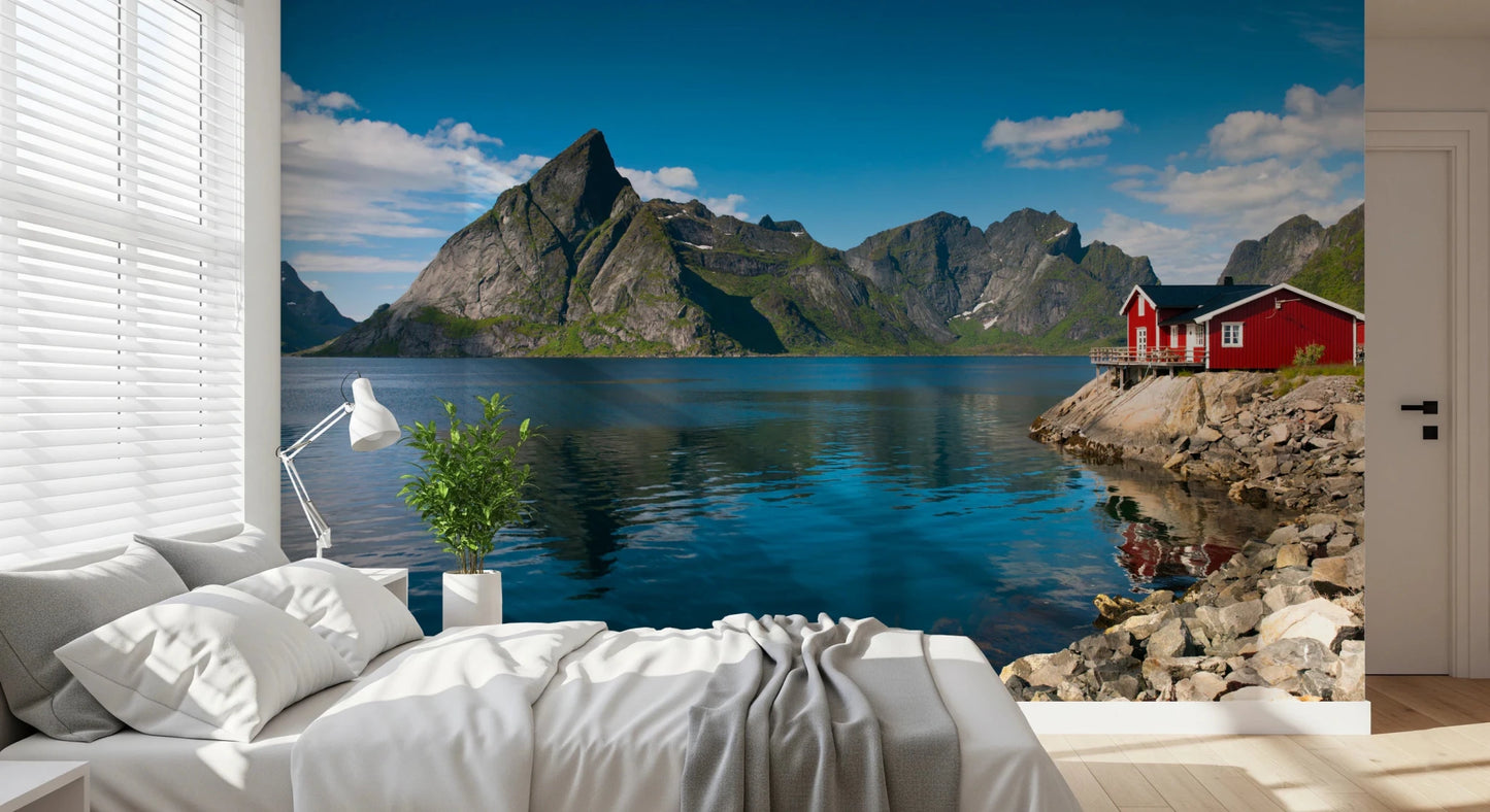 Fishing huts wallpaper mural of a blue fjord and mountains behind a white bed in a bright airy bedroom