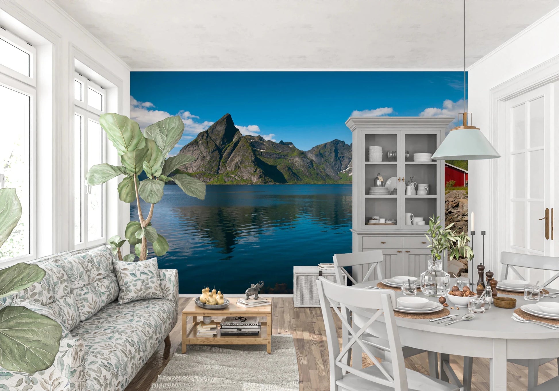 Fishing huts wallpaper mural of a fjord and red cabin in a white living-dining room with a floral sofa and round table