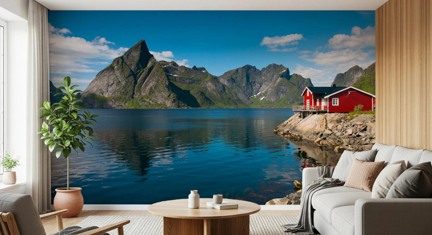 Fishing huts wallpaper mural of a calm blue fjord and red hut behind a cream sofa in a wood-panelled living room