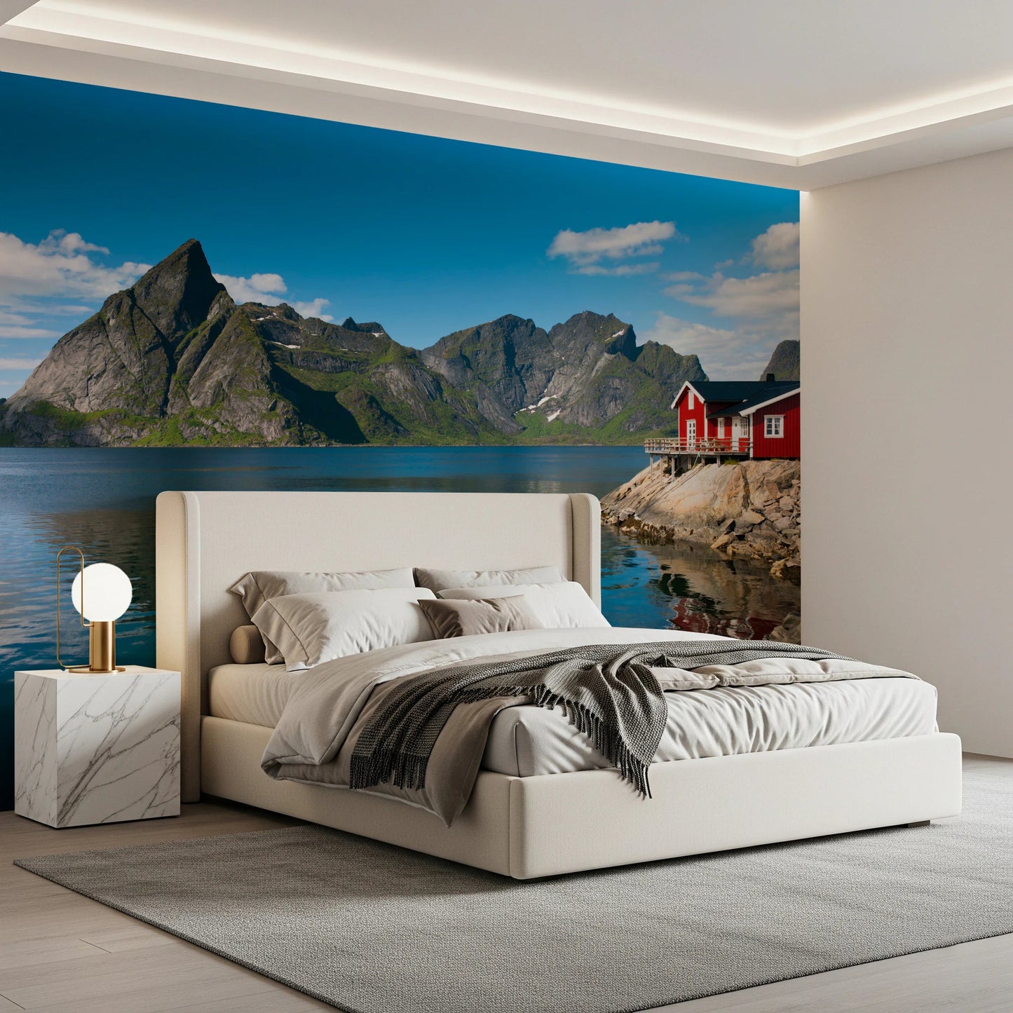 Fishing huts wallpaper mural of grey mountains over a fjord above a cream upholstered bed in a modern bedroom
