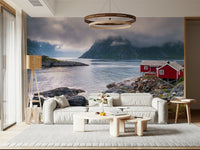 Panoramic fjord mural capturing dramatic mountains and a solitary red cabin by the water’s edge.