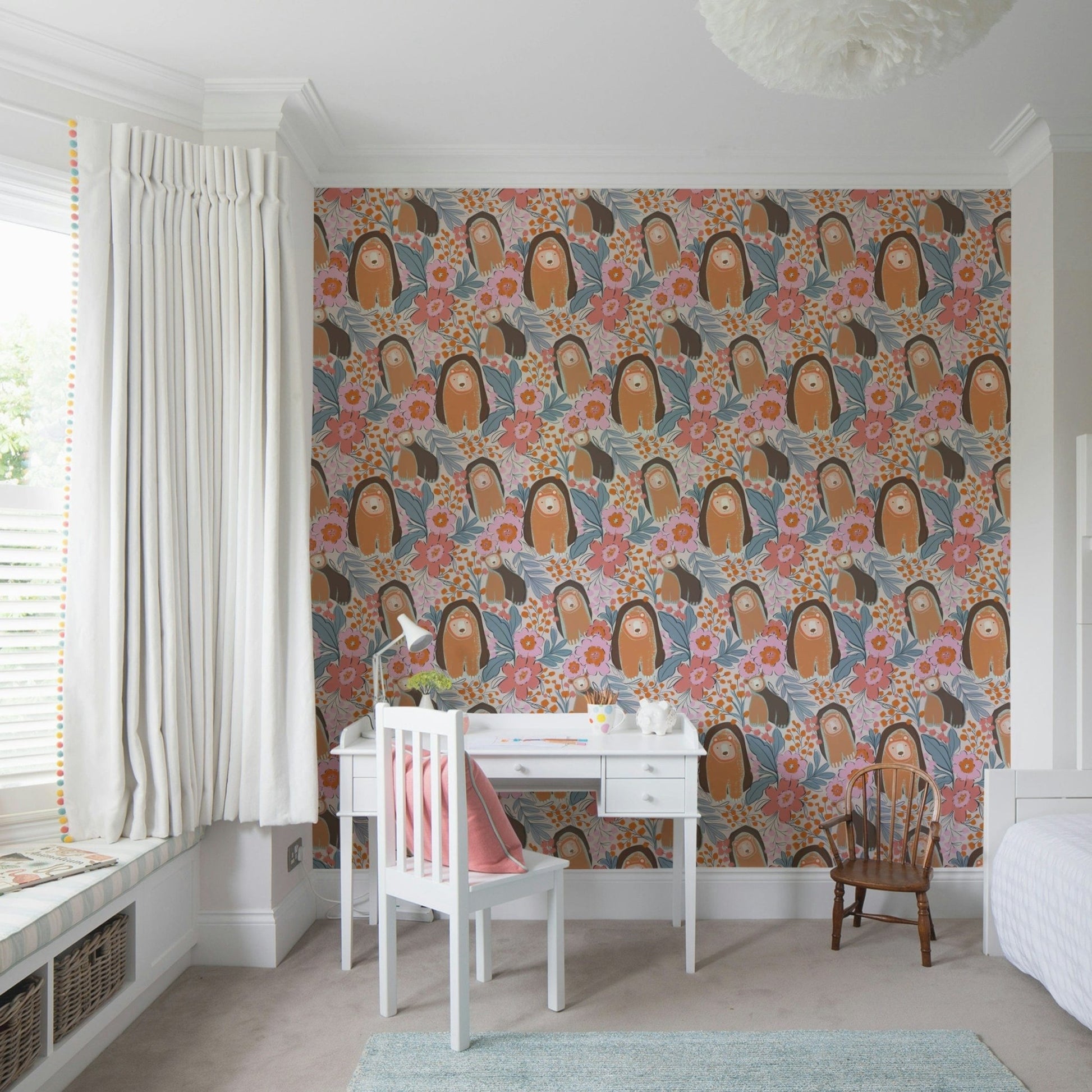 Floral bear wallpaper behind crib in nursery, calm beige and pink color tones