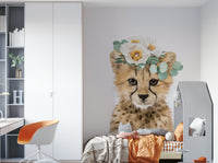 Floral cheetah cub with a whimsical garden mural

