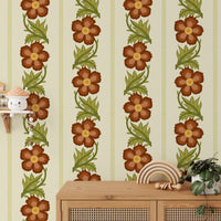 Floral Stripe Red wallpaper, rust blooms on cream stripes above a rattan cabinet in a kids room