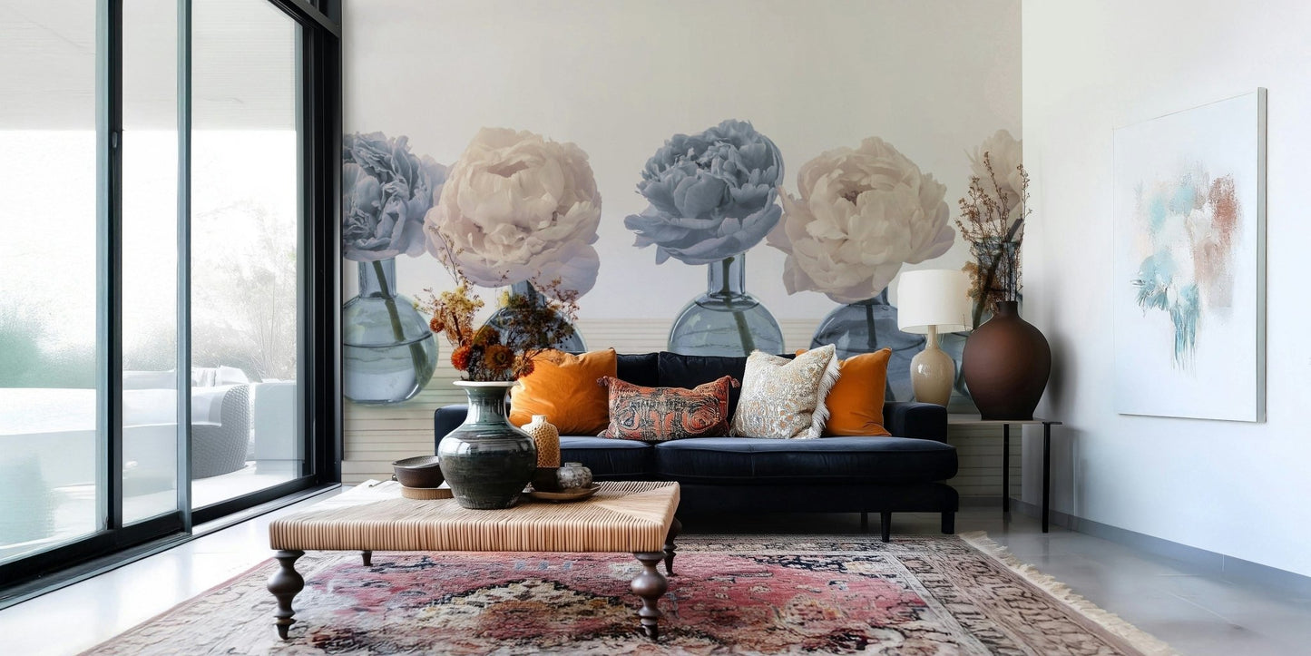 Floral Vases wallpaper mural of blue and cream peonies behind a navy sofa with orange pillows in a living room