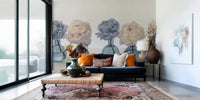 Floral Vases wallpaper mural of blue and cream peonies behind a navy sofa with orange pillows in a living room