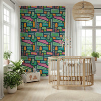 A playful patchwork wallpaper with mixed floral motifs and rainbow-bright shapes on a dark background.