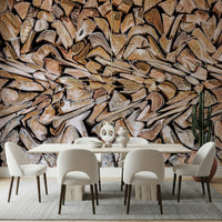 Fractured Timber wallpaper mural of split firewood behind a light wood dining table and cream chairs