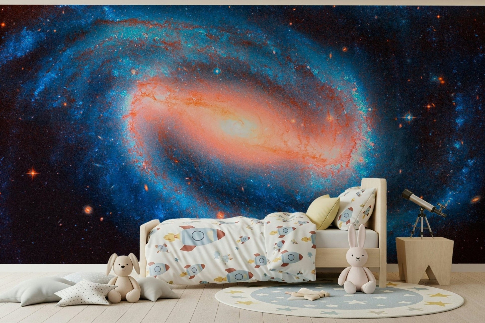 Galaxy Dream wallpaper mural of a spiral galaxy and stars in a child's room with a wood bed and telescope