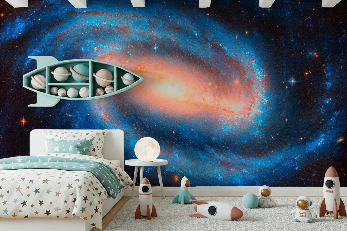 Galaxy Dream wallpaper mural of a blue galaxy and stars in a kids room with a teal rocket planet shelf