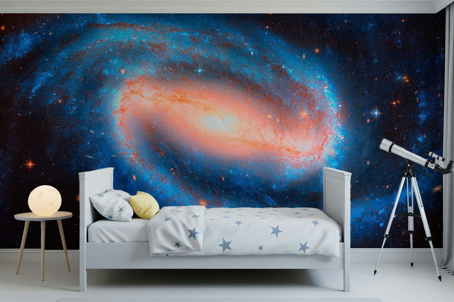 Galaxy Dream wallpaper mural of a glowing spiral galaxy behind a white kids bed with a telescope nearby