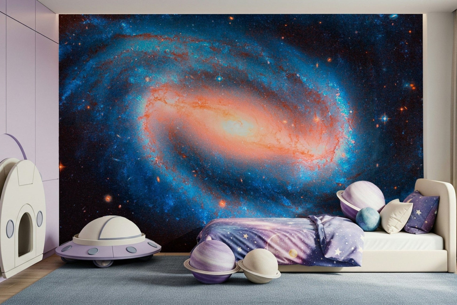 Galaxy Dream wallpaper mural of a deep blue galaxy in a child's room with a cream bed and purple UFO toy